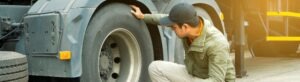 image of man checking tires for dot truck inspection