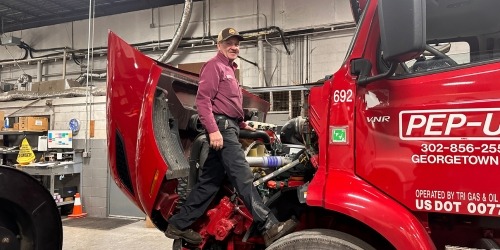 image of diesel mechanic working on heavy duty truck engine
